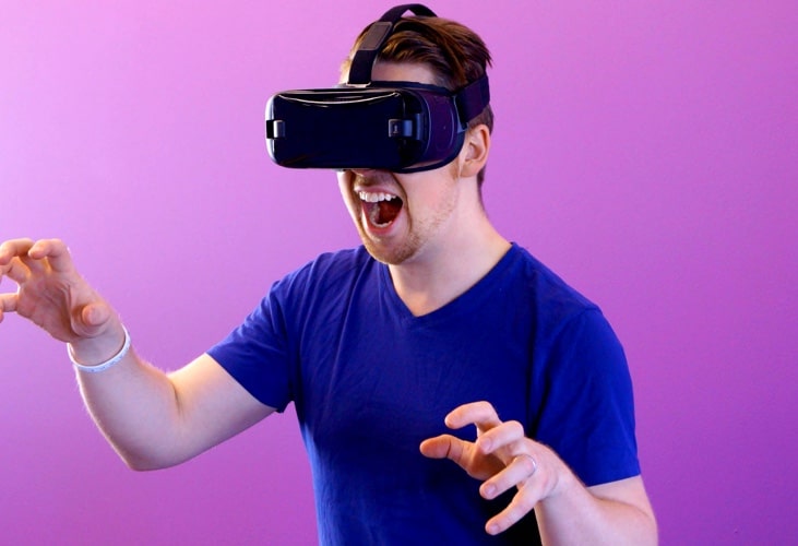 Man in blue shirt with a VR headset